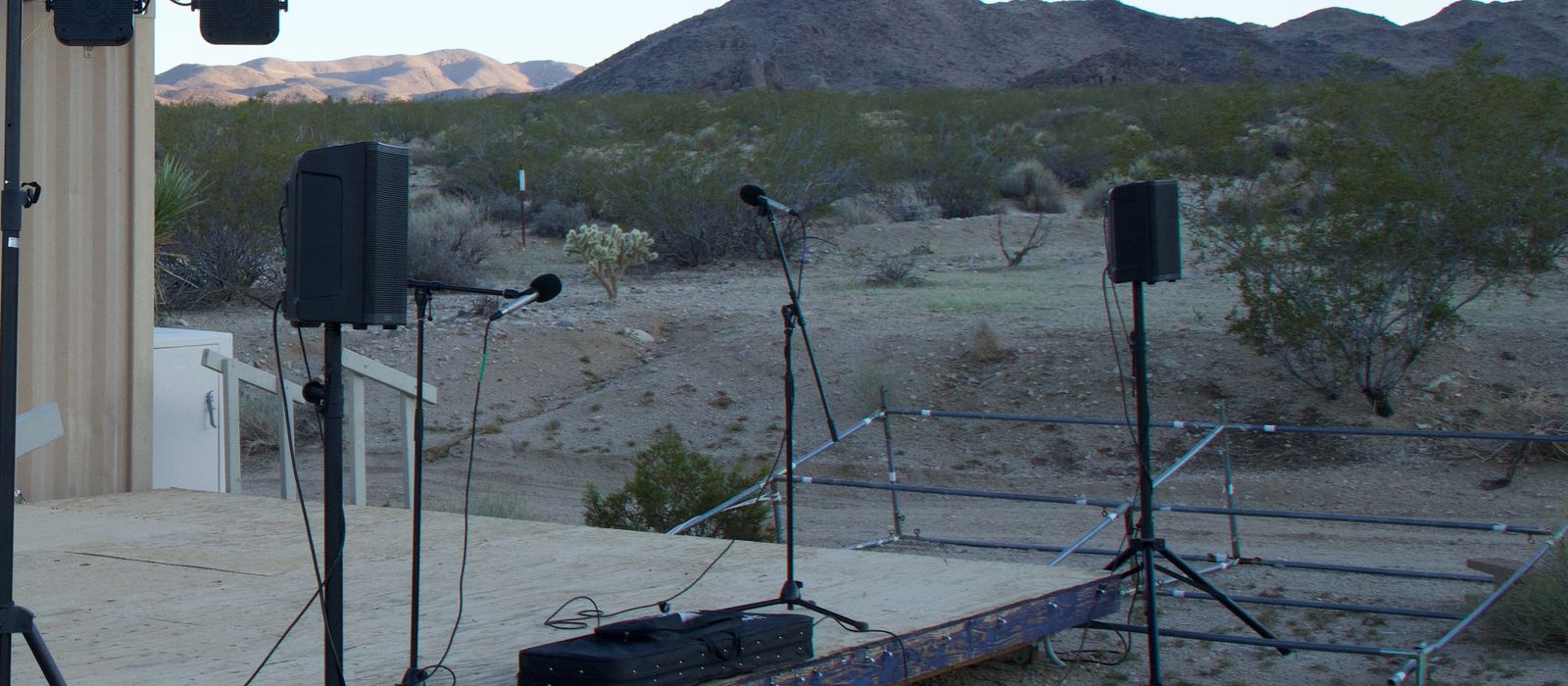 Outdoor festival stage with lighting truss and speakers set up before the show